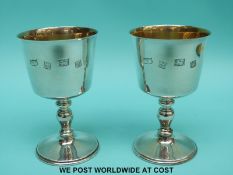 A pair of Mappin and Webb feature hallmarked silver goblets with gilt wash interiors,