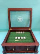 A coin chest with 'Never Circulated US State Quarters' to glazed lid containing fifty two silver