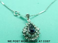 An 18ct white gold pendant set with pear cut sapphire surrounded by diamonds in a layered design