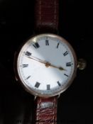 Swiss 9ct gold wristwatch with gold hands, Roman numerals and white enamel face,