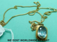 A 9ct gold pendant set with a synthetic spinel on 9ct gold chain (7.