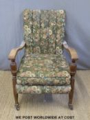 A late 19thC/early 20thC armchair with sweeping arms and part reeded supports