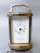 A Charles Frodsham London oval cased carriage clock, with curved bevelled glass,