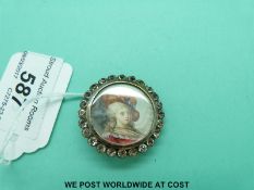 A Victorian white metal button with portrait to the centre surrounded by a paste set border