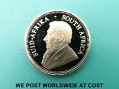 A cased 1/4oz gold Krugerrand with certificate of authenticity