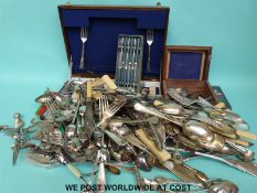 A large quantity of plated cutlery including collectors' spoons