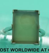 An 18ct gold ring set with a rectangular gemstone depicting a photo of a child in a platinum