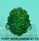 A white metal ring set with carved jadeite (size I)