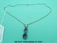 A late Victorian necklace marked 9ct gold set with three graduated amethysts, in original box.