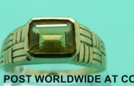 A 9ct gold ring set with an emerald cut citrine (size X)