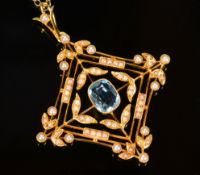 A 15ct gold Edwardian pendant set with an aquamarine and seed pearls in a square design on an 18ct