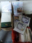 Three boxes of various designs of table cloths including lace examples,