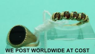 A 9ct gold signet set with onyx and a 9ct gold ring set with garnets