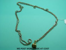 A 9ct gold guard chain made up of small spherical links with star design and a fob set with a seal