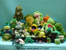 A collection of ceramic and soft toy frogs