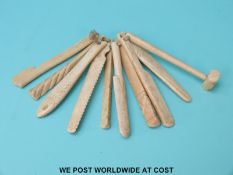 A small collection of possibly prisoner of war carved bone and ivory items to include saw, fish,