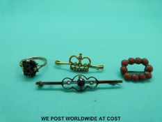 A yellow metal brooch in the form of a crown set with seed pearls,