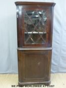 A Georgian mahogany double height corner cupboard,