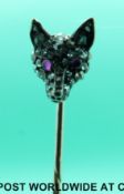 A Victorian stick pin in the form of a fox's head set with rose cut diamonds and ruby eyes