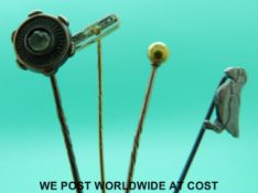 Three yellow metal stick pins one set with diamonds and a white metal stick pin in the form of a