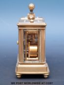 A brass cased miniature carriage clock and barometer compendium with enamelled dials,