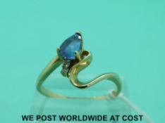 An 18ct gold ring set with a tanzanite and diamonds in a twist setting (size T)