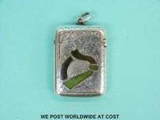 An early 20thC hallmarked vesta with hardstone Irish harp decoration to front,