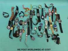 Over 40 various ladies and gentleman's fashion wristwatches some Swatch style.