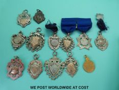 A collection of hallmarked silver fobs awarded to Miss M Ingram gymnast,