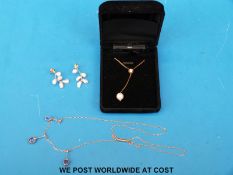 A yellow metal necklace set with three amethysts,