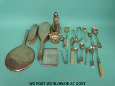 A hallmarked silver mounted three piece dressing table set comprising hand mirror and two brushes,