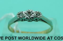 An 18ct gold ring set with three diamonds in a platinum setting (size O)