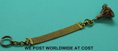 A Victorian intaglio fob with lion motif on a yellow metal braided ribbon with decorative