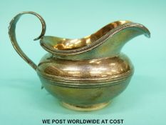 A Victorian hallmarked silver cream jug with gilt wash interior,