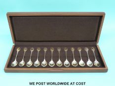 A cased set of 12 hallmarked silver RSPB spoons with gilt bird in panel to top of each (328g)