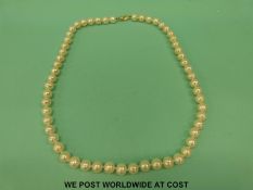 A single strand pearl necklace with 14ct gold clasp