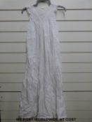 A quantity of late Victorian/Edwardian christening gowns with lace decoration to the cuffs and neck