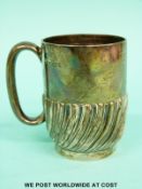 A Victorian hallmarked silver christening mug with wrythen decoration,