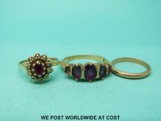 A 9ct gold ring set with a ruby surrounded by diamonds,