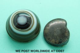 A large banded agate cabochon brooch and a mounted polished ammonite