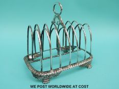 A Georgian hallmarked silver six division hallmarked silver toast rack of double Gothic arch design,
