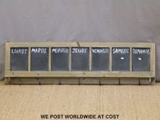 A French week planner blackboard with hooks,