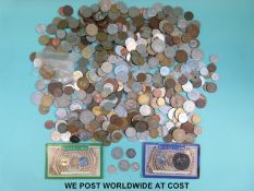 A collection of overseas coinage together with a 1950 visitor's badge Berlin Parliament,