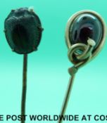 A yellow metal stick pin set with a scarab beetle and an early Victorian stick pin set with a