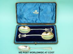 A cased pair of Art Nouveau hallmarked silver spoons with part gilt decoration,