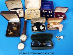 A collection of cufflinks and studs, some gold plated, two watches,