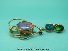 A yellow metal brooch set with an opal doublet and a pair of 9ct gold earrings set with synthetic
