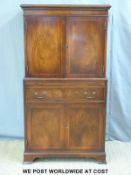 A mahogany reproduction drinks cabinet/tallboy having two cupboards over and two under with drawer