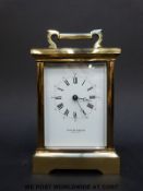 Taylor and Bligh brass carriage clock, in corniche style case with white enamel dial,