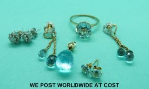 A suite of 9ct gold jewellery set with blue topaz comprising pendant, earrings and ring,